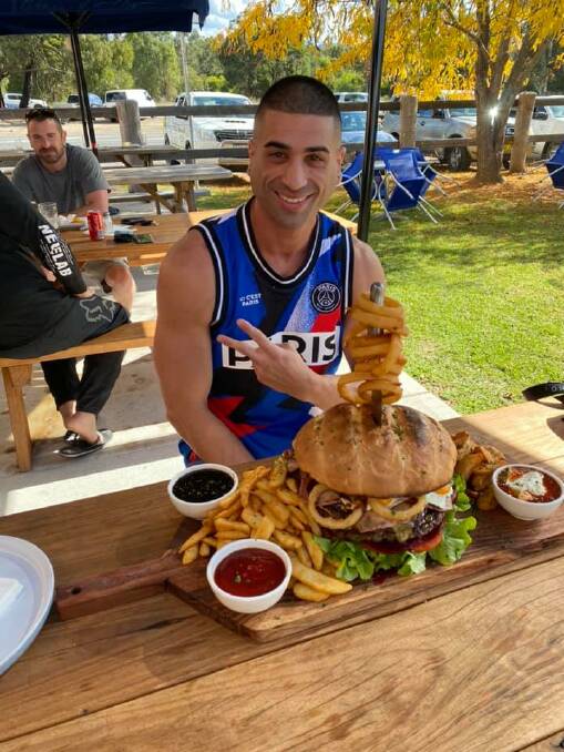 A PIECE OF CAKE: James Webb of Baulkham Hills became the first person to devour the burger monster.