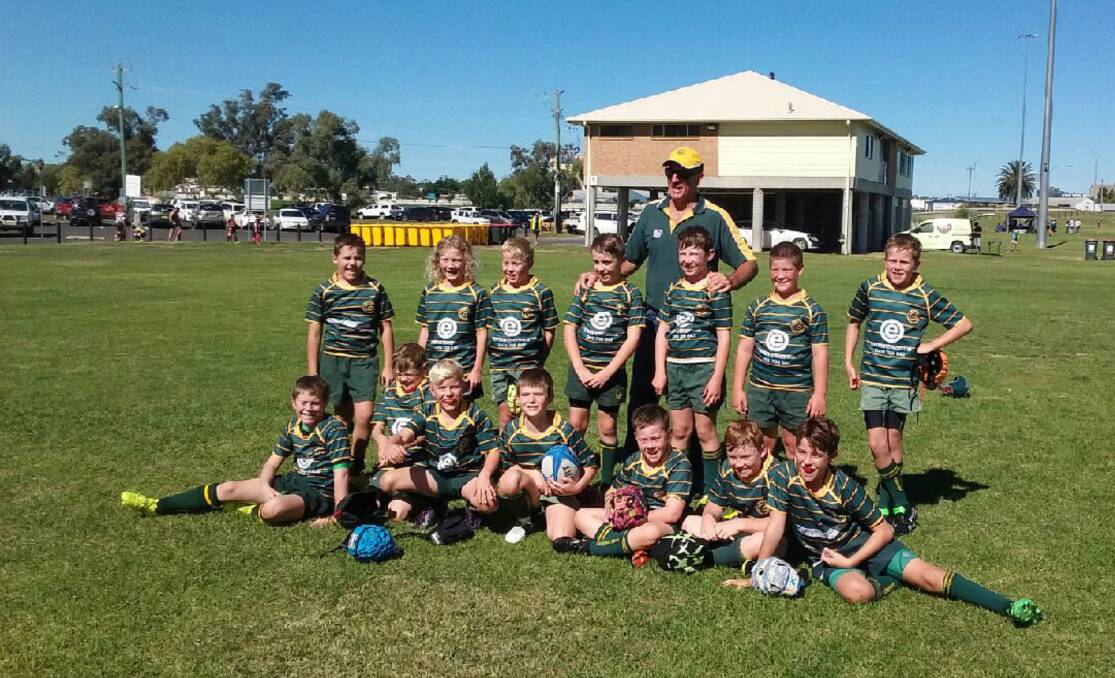 WELL DONE: The Inverell Junior Highlanders came away with a final fourth place finish in Tamworth on the weekend. They are pictured with coach Rob Sides. Photo by Ziz Williams