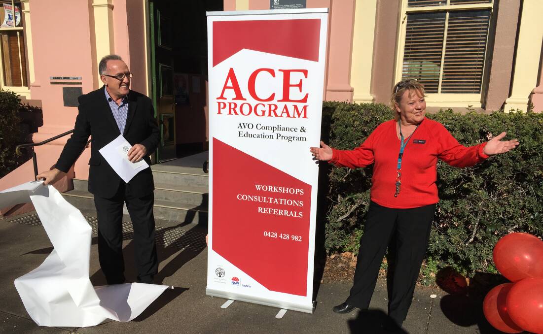 It's official: Inverell Shire Council's Acting Mayor Anthony Michael unveils the ACE banner with Kerrianne Anderson at Inverell Court House on Thursday. Photo: Heidi Gibson
