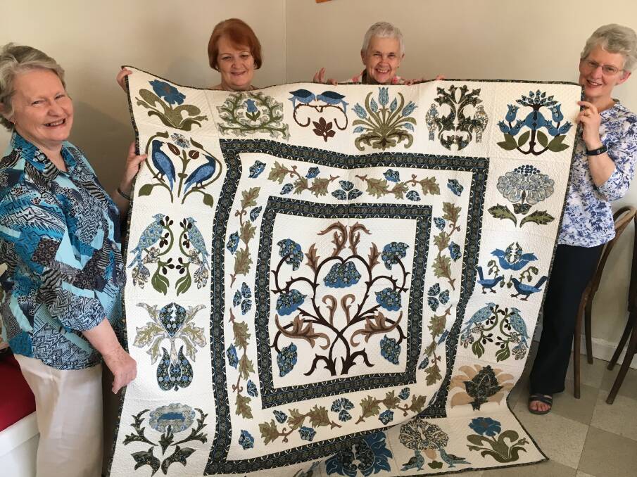 Grand prize: Sisters in Stitches members Ann Tubb, Leigh Rex, Mary Jordan and Rhonda McGregor with the quilt to be raffled. Photo: Heidi Gibson