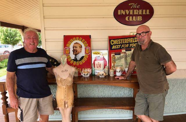 Auction organiser Robert Walburn and auctioneer Peter Squires looking over a display of Inverell memorabilia included in the auction. Pictures supplied.