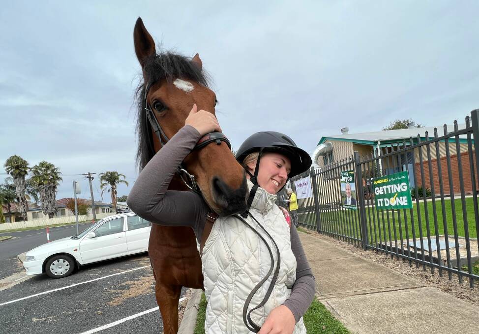 GETTING IT DONE: Inverell's Gabby Realpe rode to vote in style, with Dash not minding a munch on the grass while he waited. Photo: Jacinta Dickins