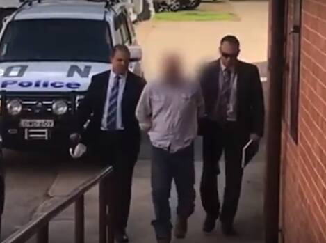 Detectives from Tuggerah Lakes Police District lead James Scott Church to Inverell Police Station on Thursday.
