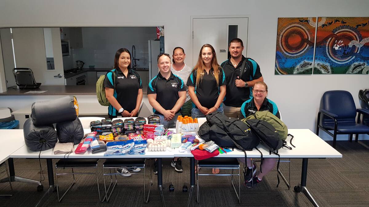 The Linking Together staff with some of the items available for free to our local homeless