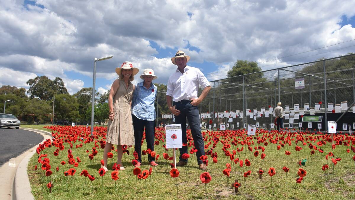 Cr Kate Dight, Julie Regan and Colin Dight at the field of hand-made poppies, Varley Oval.