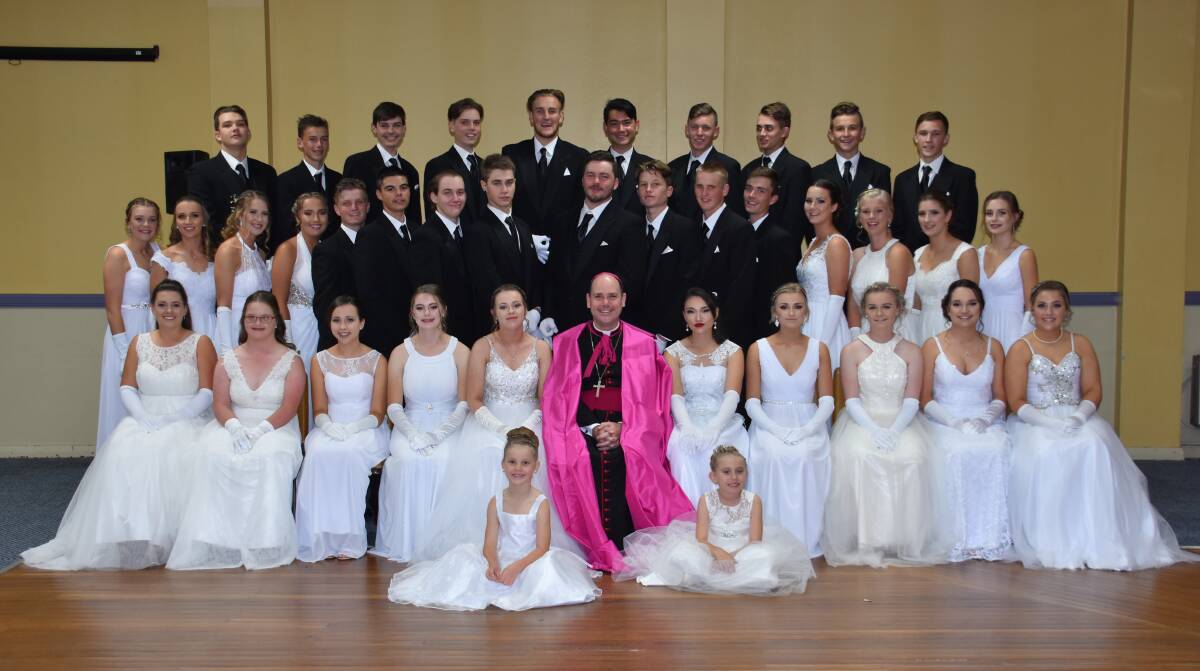 Most Rev. Michael Kennedy, Bishop of the Diocese of Armidale, with the young debutantes and their partners.