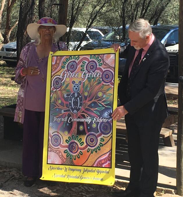 Aunty Elizabeth Connors and Inverell mayor Paul Harmon with a banner from the Giree Giree elders, to mark the occasion.
