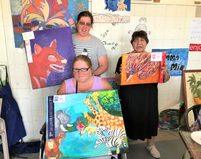 Cristen Taber, Pam Creighton and (seated) Samantha Forster with their Inverell Show-winning paintings. Photo: Kellie Uebergang