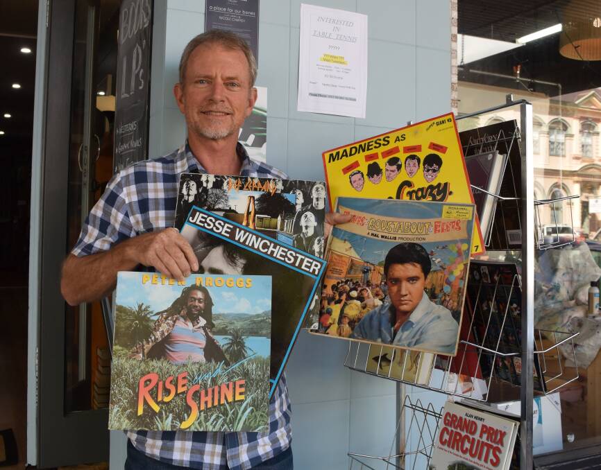 Garry Newley shows off some of the Orpheus Bookshop record collection.
