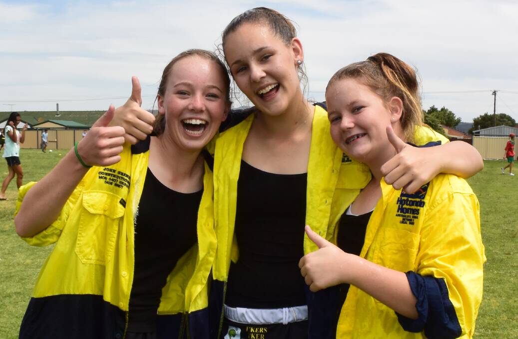 GOOD FUN: Ellie Degunst, Sienna Smith and Millie Green were soaked and in high spirits.
