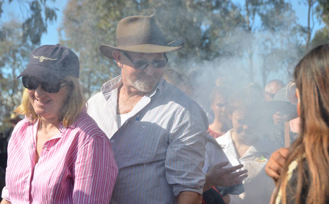 Attendees to the commemoration are cleansed with a smoking ceremony.  
