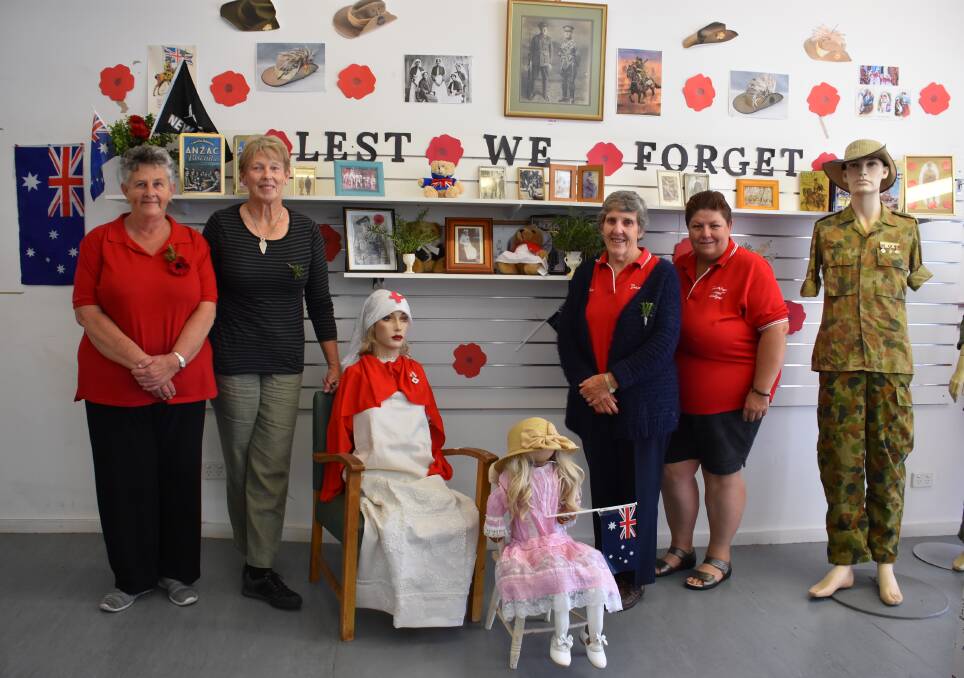 Michelle Maxwell, Annie Soutter, Marilyn Ellis and Sallyan Iskov with the store's Anzac Day display. 