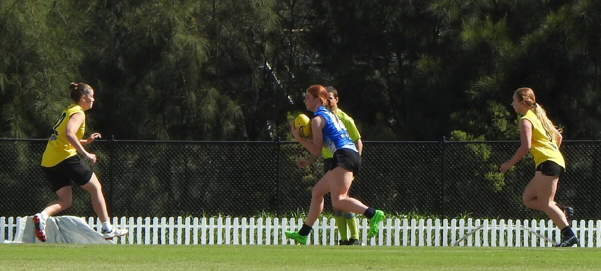 Elle Ford goes up against three Canberra players during the selection trials in Blacktown.