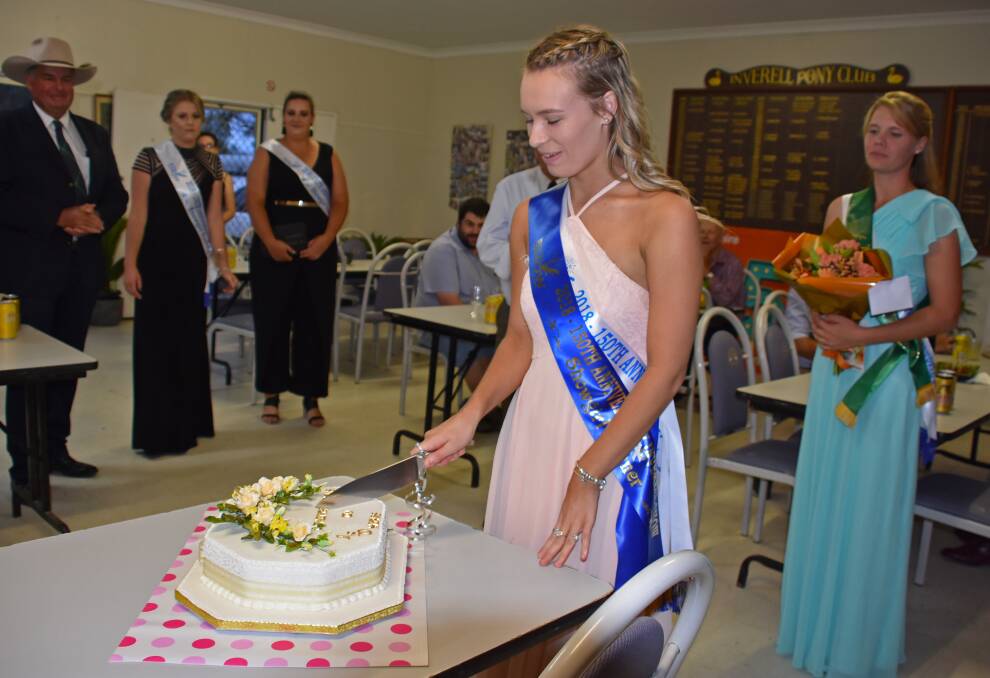 Gaby Watkins cuts a cake to celebrate 150 years of the Inverell Show. 