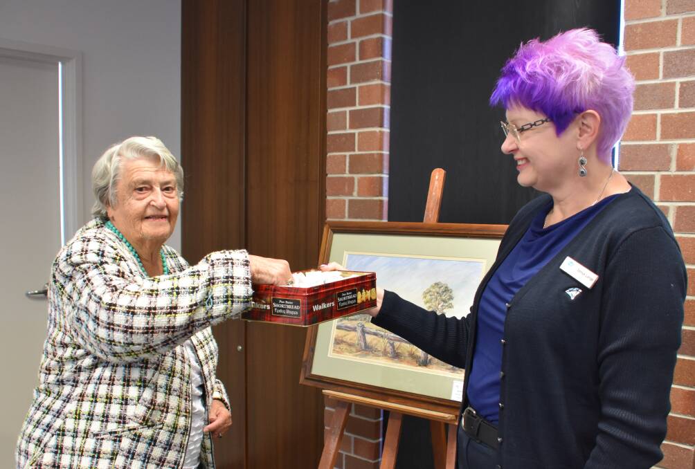 Beryl Hamilton, pictured with Sonya Lange, draws the winner of her Inverell Station painting. 