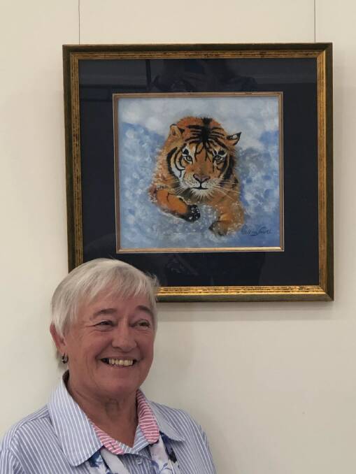 Helena South with her painting Tiger Splash, which features in the exhibition. Photo by Belinda Emerson. 