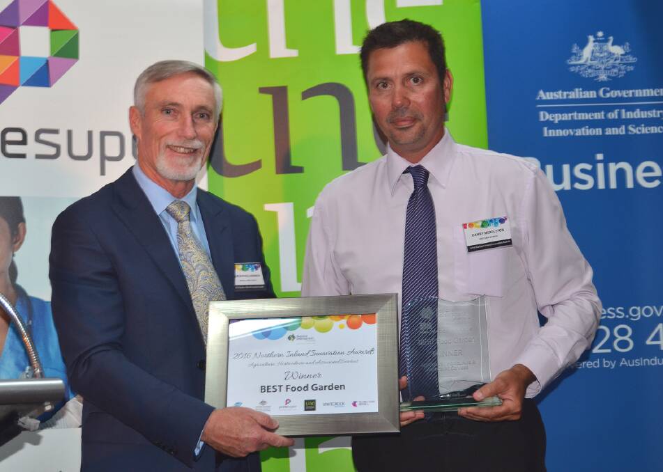 Inverell Shire mayor Paul Harmon presents the BEST Food Garden award to BEST Employment social programs co-ordinator Danny Middleton.