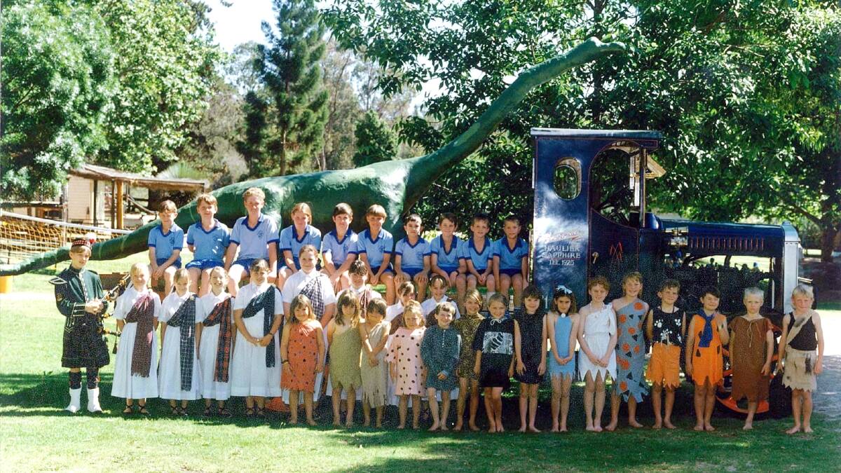 The 1995 class prepare to join the school dinosaur on a float for the Sapphire City Festival parade. 