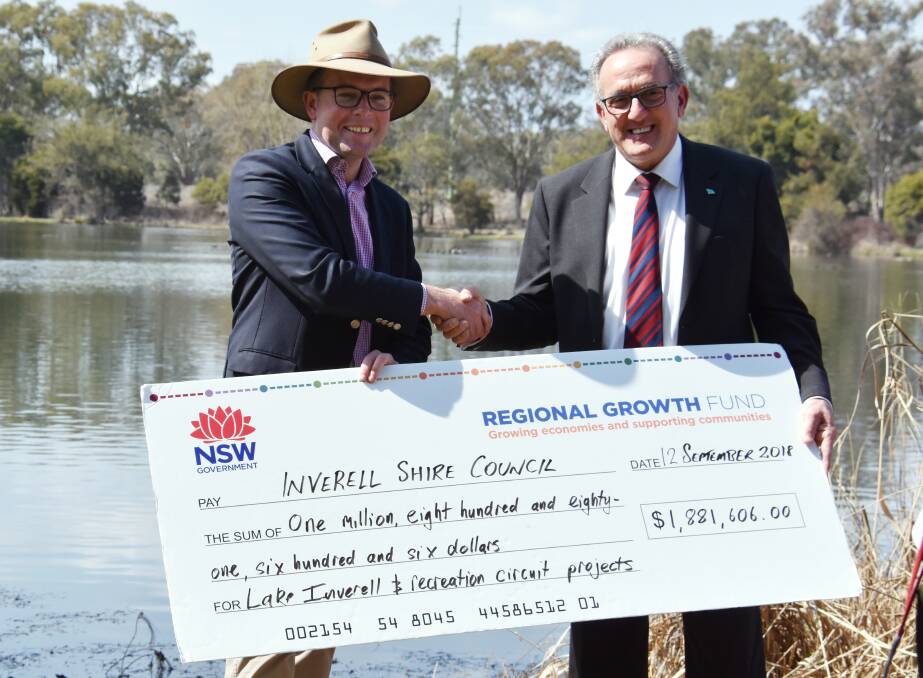 Member for Northern Tablelands Adam Marshall hands over the state government funds to deputy mayor Anthony Michael. 