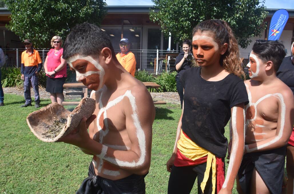 Elijah Brown, Brianna Brown and Todd Knight perform the smoking ceremony.
