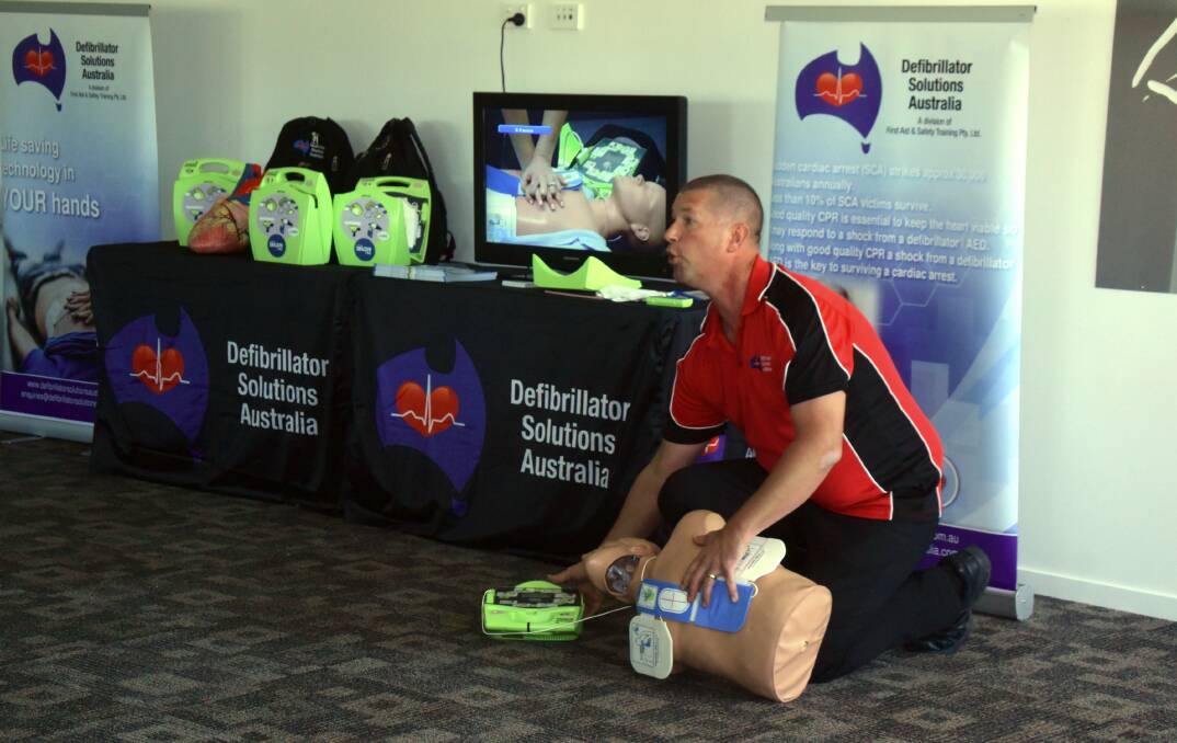 John Moelker teaches locals how to use a defibrillator.