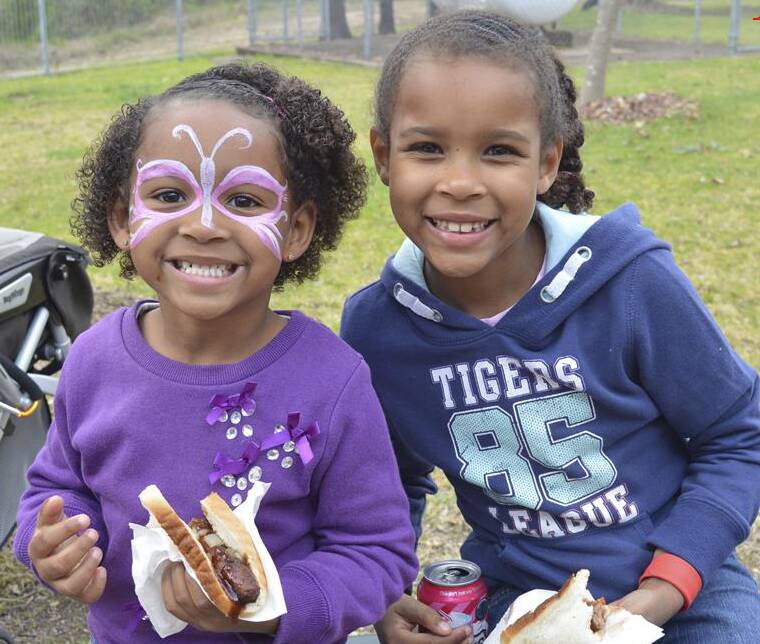 Elirah and Ella Mills enjoy face painting and a barbecue during a Gilgai fete. 