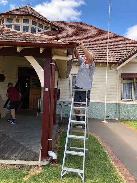 Inverell Club Committee member Robert Walburn repairing a ridge capping tile during one of the many volunteer working bees.
