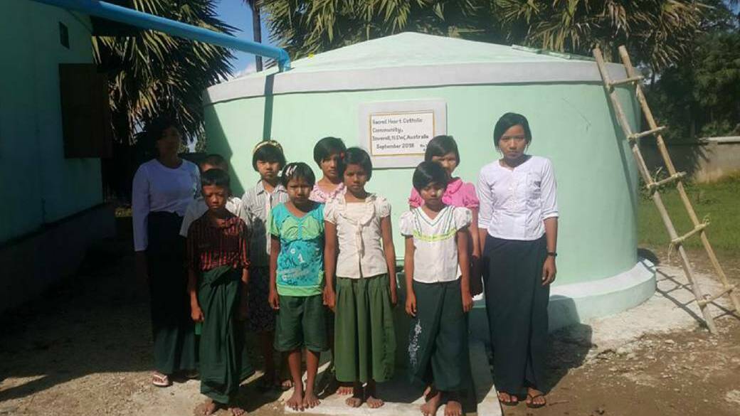 Children in Myanmar with one of the donated tanks.