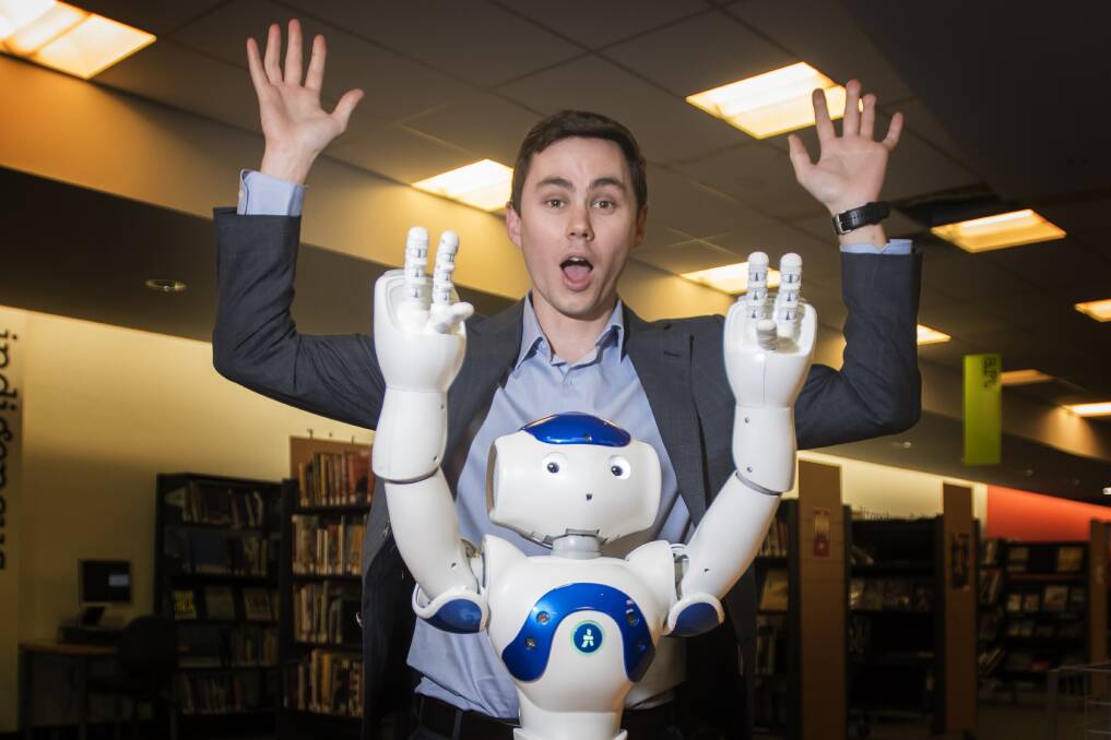 DO AS WE DO: New England North West Business Chamber president Joe Townsend with a robot. Photo: Peter Hardin