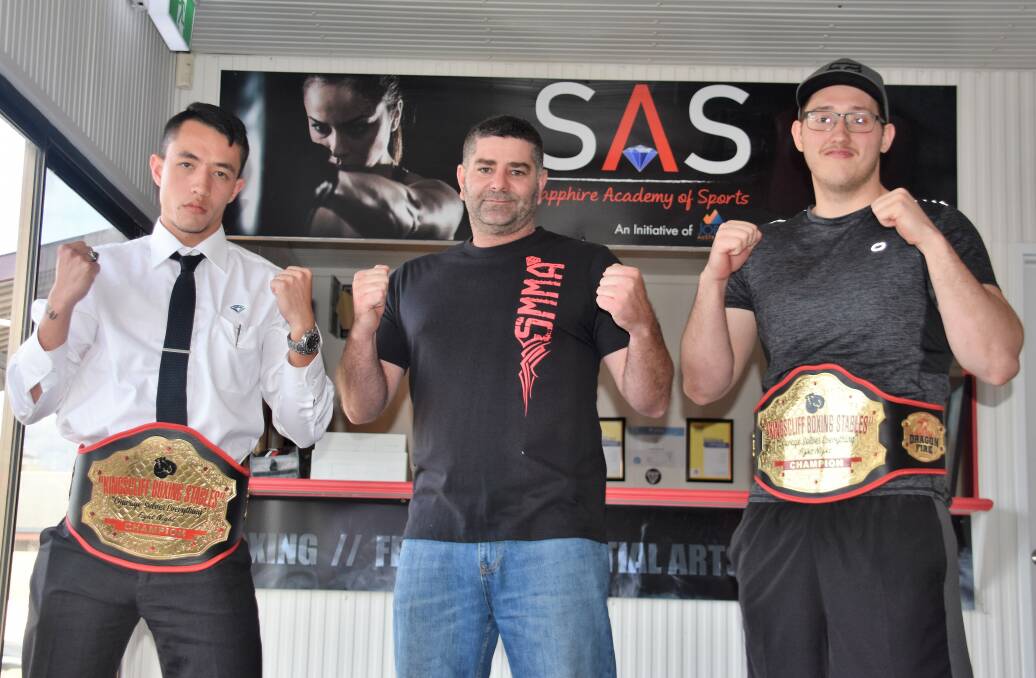 RESULT: Sapphire Academy of Sport fighters Rod Prentis and Nathan Krauss wear their champion belts with manager Darren Finn (middle).