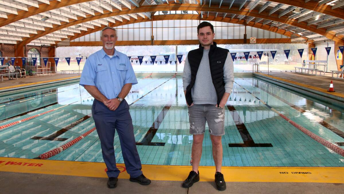 Mayor Paul Harmon with pool operator, New England Aquatics Kyle Schuman inside the current Inverell pool facility.