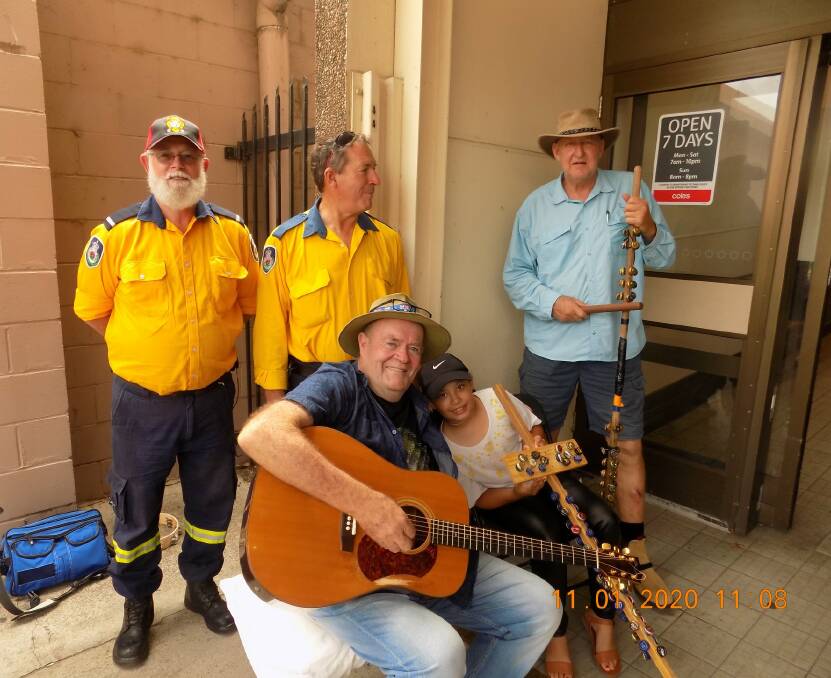 Fundraiser: Members of the Inverell Rural Fire Service with Michael O'Sullivan and fellow musicians playing at the back entrance of Coles.