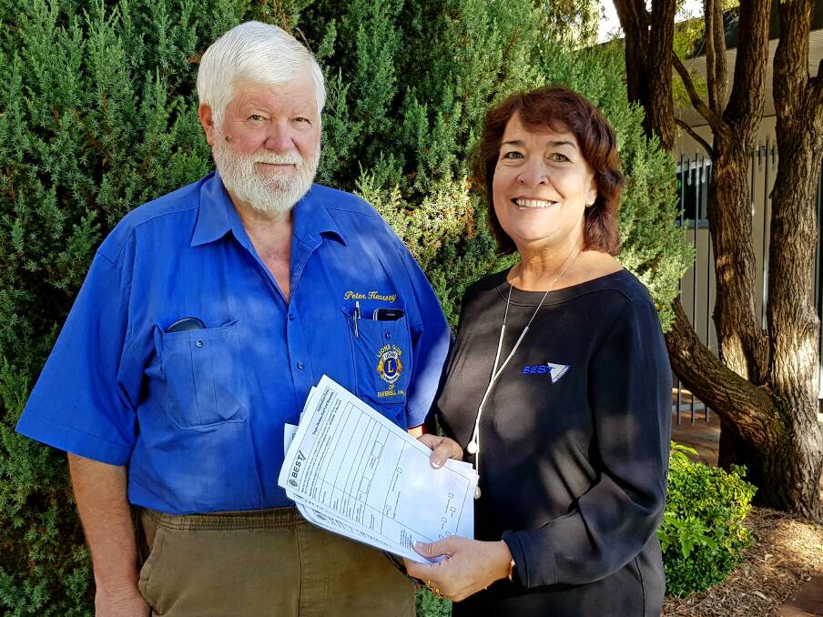 Assisting those in need: Inverell Lions Club member Peter Kearsey and BEST CEO Penny Alliston-Hall with application forms.