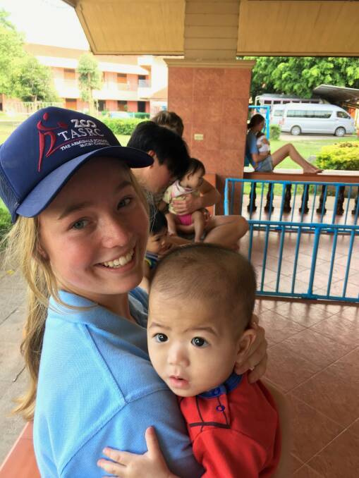 Ellie De Gunst makes friends at the Agape Home for HIV Orphans in Chiang Mai,
Thailand.