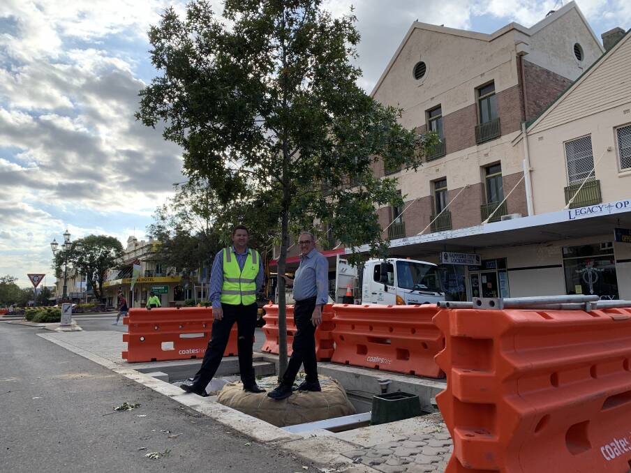 Inverell Shire Council's Justin Pay and Anthony Michael check out the progress of Byron Street's renewal project after tree planting.