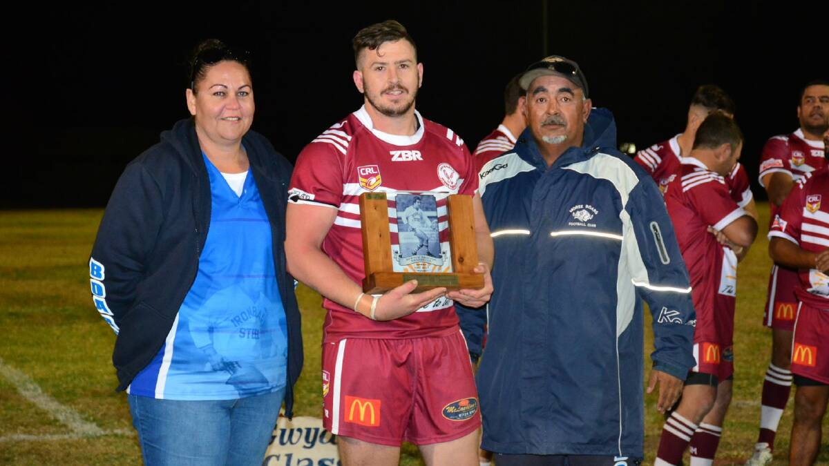 Inverell Hawks captain accepting the Bernie Briggs Memorial Trophy from Moree Boars' Club members.