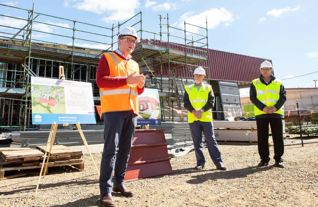 Member for Northern Tablelands Adam Marshall with mayor Paul Harmon and deputy mayor Anthony Michael inspect progress of the new building last year.