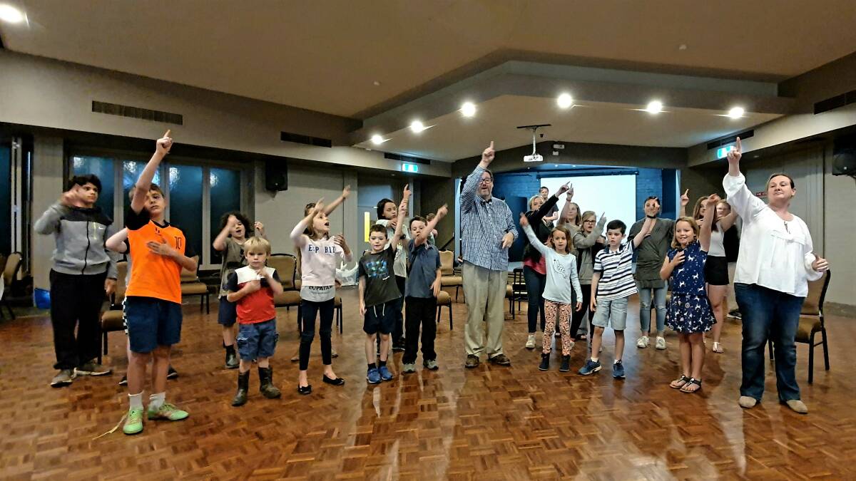 Craig Maynard (centre) guides some of the Unstop-Ability performers in a rehearsal of an Auslan-interpreted number last week. photo: Michèle Jedlicka.