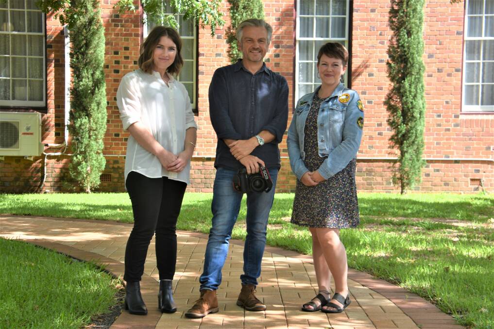 Grant: Jessika Schmidt and Em Williams from Womens Domestic Violence Court Advocacy Service New England with photographer Simon Scott (middle).