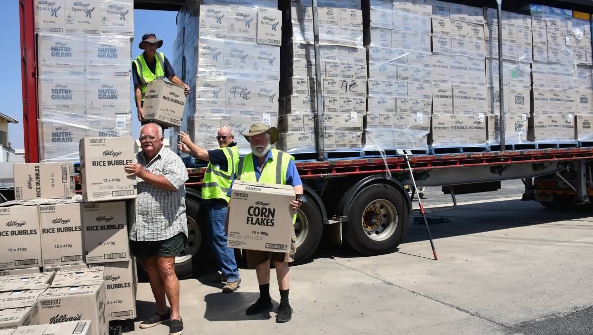 Tom Cattell, John McGufficke, Peter Jarrett and Peter Kearnsey unload the Linfox truck full of Kellogg's products on Wednesday.