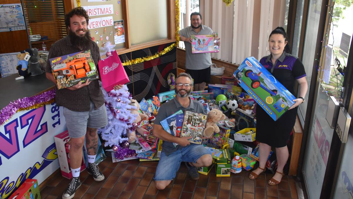 Generous: The team at 2NZ and Gem FM Peter Mason, Dave Risby, James 'Monte' Irvine and Tayla Mepham with some of the many toys and books donated this year.