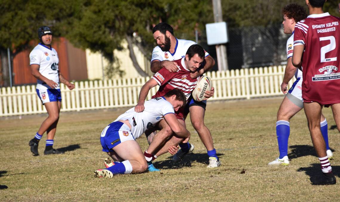 Old-school rugby league: Inverell Hawks' Joe Ferris fights off two Moree Boars players in first grade on Saturday. More photos online.