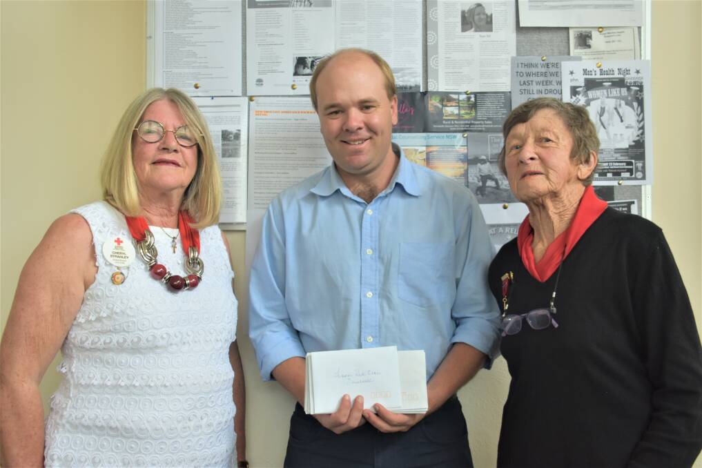 Donation: Cheryl Strahley, Inverell Rural Financial Counsellor Geoff Mill and Marjory Schmidt with the IGA vouchers.