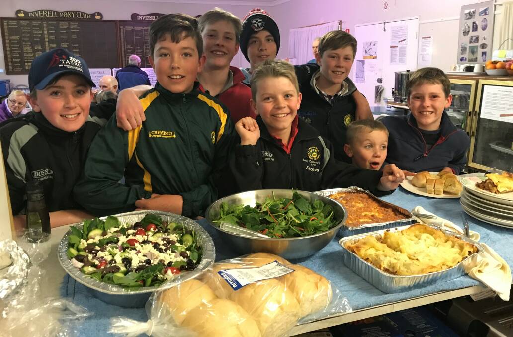 On the menu: Inverell Junior Rugby Union players prepare to help serve a delicious feast for BlazeAid Volunteers helping rebuild fire damaged boundary fences.