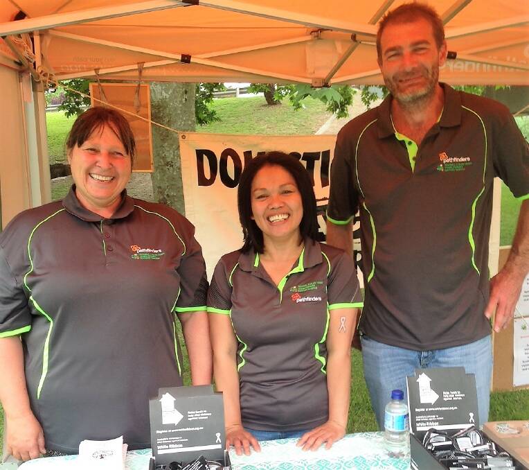 Pathfinders' Trish, Daisy and Tim at their White Ribbon awareness stall at last year’s Sapphire City Festival.