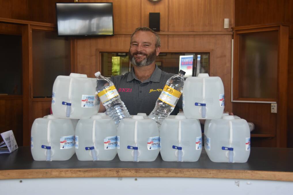 Helping hand: 2NZ breakfast host James 'Monte' Irvine with the first lot of donated water for Bundarra residents.