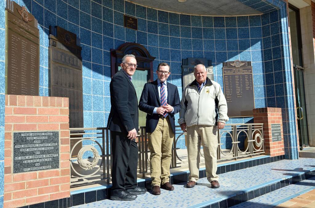 Inverell Shire Deputy Mayor Anthony Michael, left, Northern Tablelands MP Adam Marshall and Inverell RSL Sub-Branch welfare officer Brian McLennan in front of the memorial where the old tiles will soon be replaced.