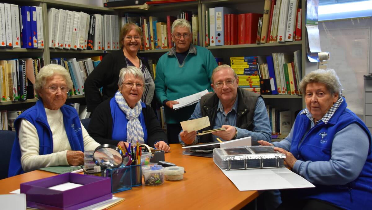 Beryl Shepherd, Gloria Baldwin, Kathy McLeod, Judy Piscke, Steve Day and Muriel Resta busy packing up the huge collection.