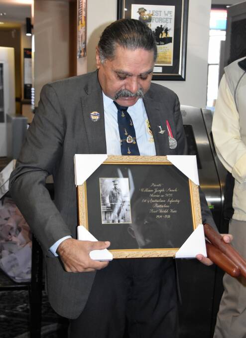 Framed portrait: Inverell's Kelvin Brown accepts the National Party's gift of WWI Aboriginal soldier William Joseph Punch which will now hang in the RSM Club.