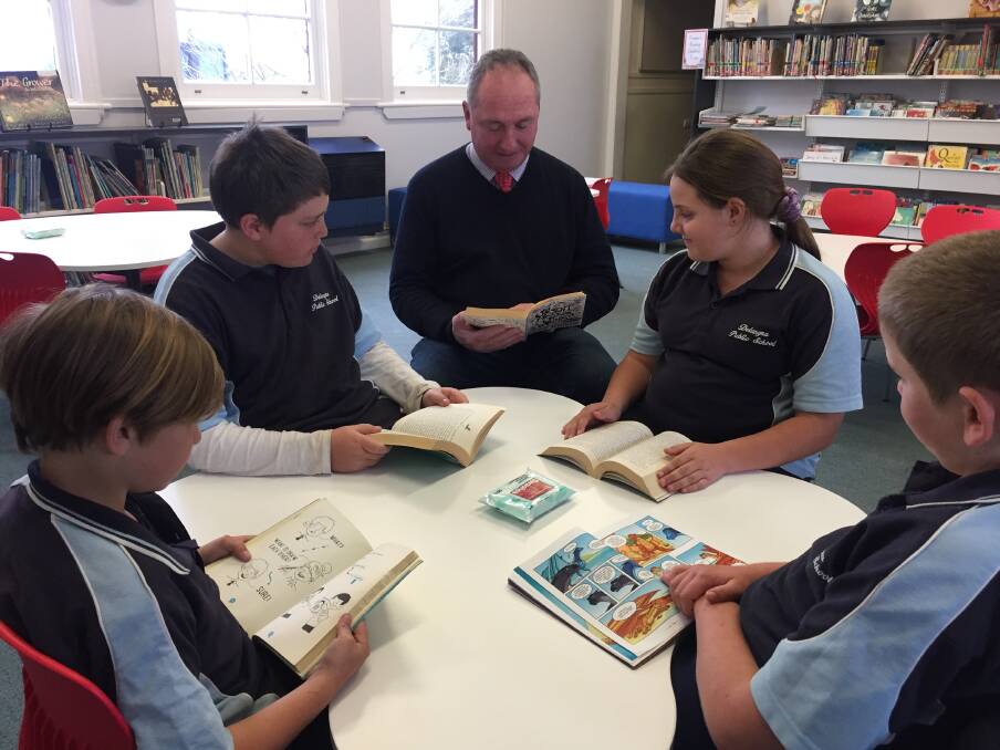 Member for New England Barnaby Joyce reading with students at Delungra Public Schools newly refurbished library. 